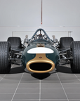 Vintage racing car on a tiled floor with a neutral background