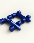 Blue plastic race car pieces on a white background