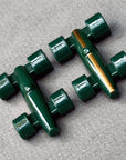 Close up of 2 Lacorsa Green race car game pieces