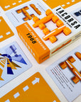 Racing board game components including cars, cards and a box labeled 'Grand Prix Seasons 1968' Papaya Orange