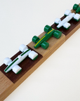 Toy race cars on a wooden checkerboard track with a white background