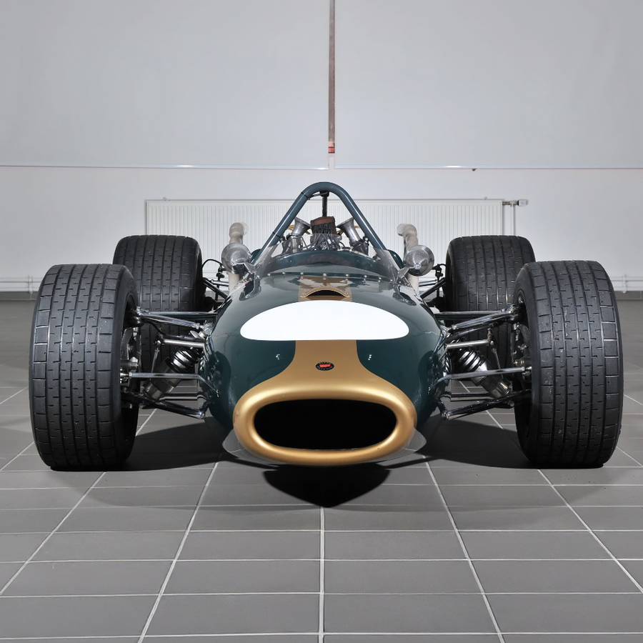 Vintage racing car on a tiled floor with a neutral background