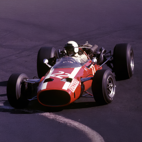 Vintage red Formula 1 car on a track with a dark background