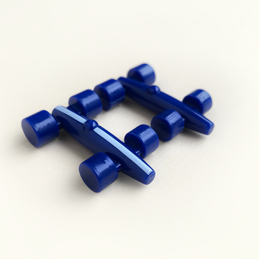 Blue plastic race car pieces on a white background