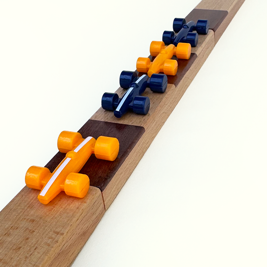 Wooden track with orange and blue cars on a white background