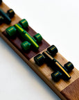 A close-up of the Lacorsa Grand Prix Board Game set, showing shiny green game pieces representing racecars on a wooden board.