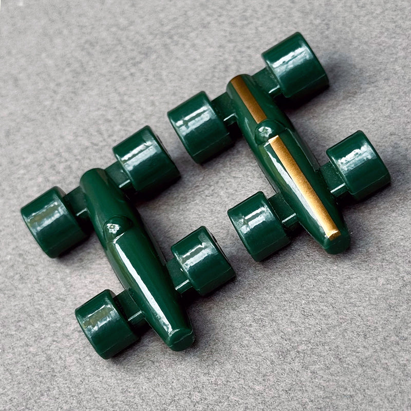 Close up of 2 Lacorsa Green race car game pieces
