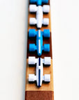 White and Medium Blue race cars on a checkered wooden race track