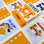 Racing board game components including cars, cards and a box labeled 'Grand Prix Seasons 1968' Papaya Orange