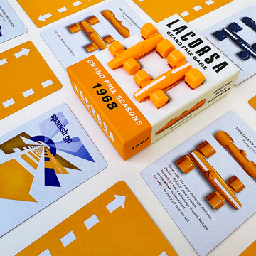 Racing board game components including cars, cards and a box labeled 'Grand Prix Seasons 1968' Papaya Orange