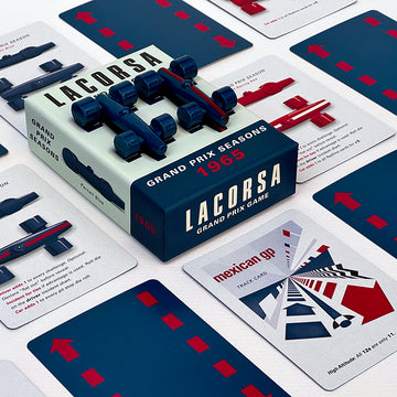 The image shows the Lacorsa 1965 Racecar Set packaging with two blue toy racecars on top and several playing cards spread out with racing themes.