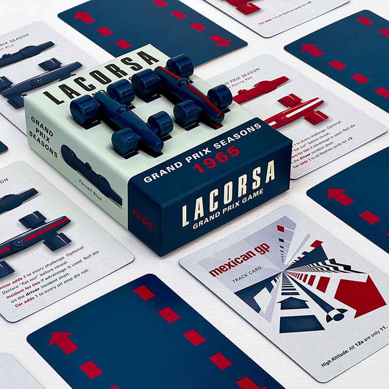 The image shows the Lacorsa 1965 Racecar Set packaging with two blue toy racecars on top and several playing cards spread out with racing themes.