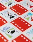 Checkerboard pattern of Lacorsa face cards and card backs laid out on a cream table.
